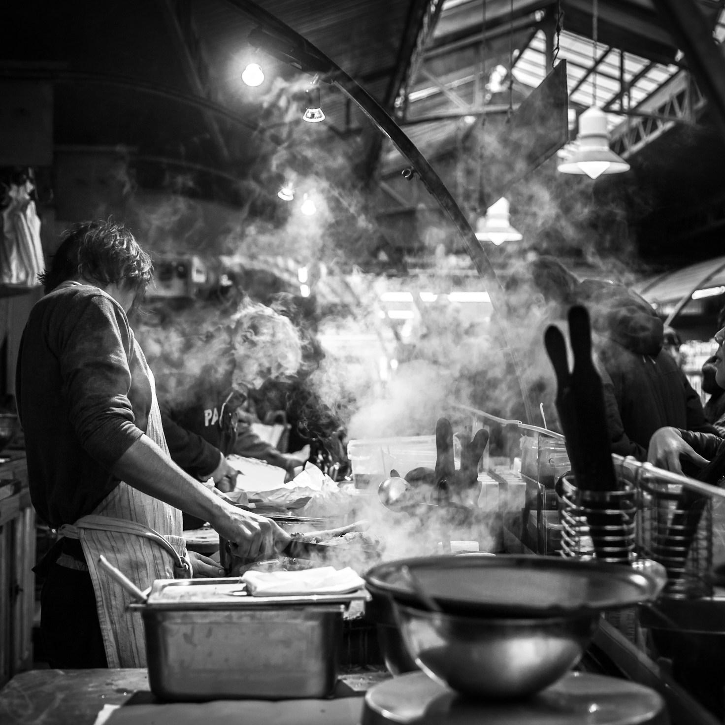 Members collaborating in a contemporary kitchen, exchanging recipes and techniques